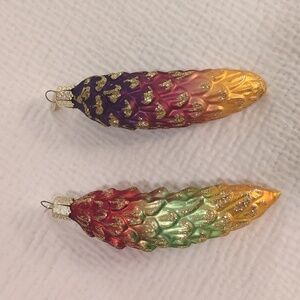 Set of 2 multicolored Old World Christmas pinecone ornaments.
